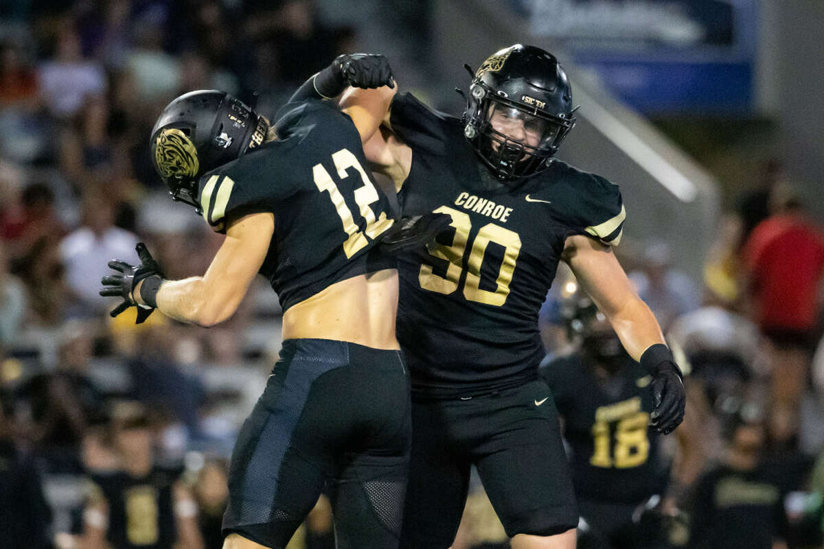 Conroe defenders Brock Ireland (12) and Matthew Westmoreland (90) celebrate after Ireland’s sack in a high school football game between College Park and Conroe Thursday, Nov 3, 2022, in Conroe.
