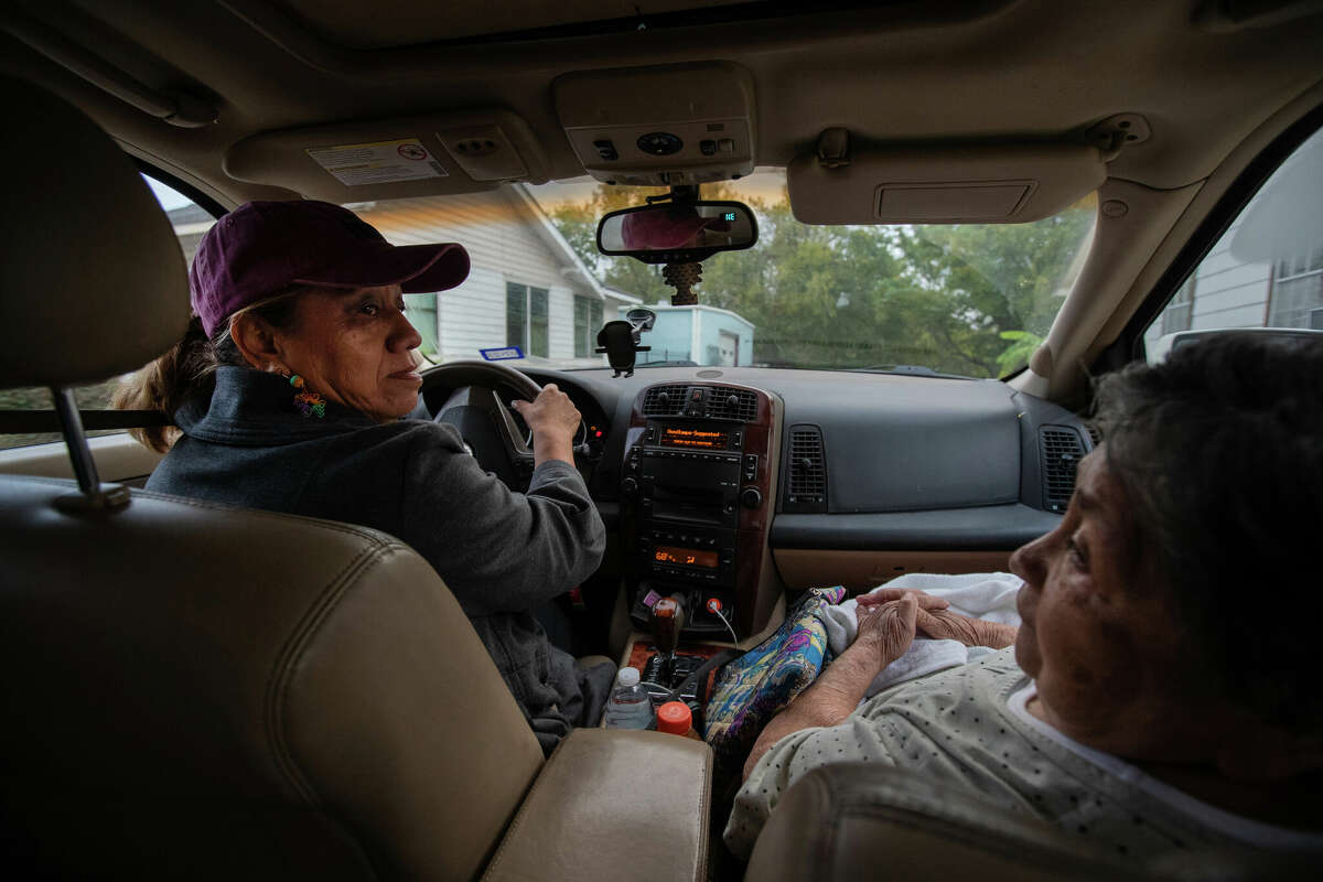 Consuelo Ramírez, left, 57, drives Carmen Hernández, right, 84, to a polling site, Thursday, Nov. 3, 2022, in Houston. Ramírez has spent years driving senior citizens to polling sites like.