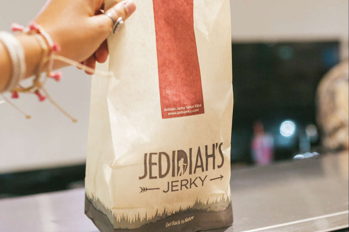 A person holding a bag of Jedidiah's Jerky located inside of EddieWorld in Yermo, CA.