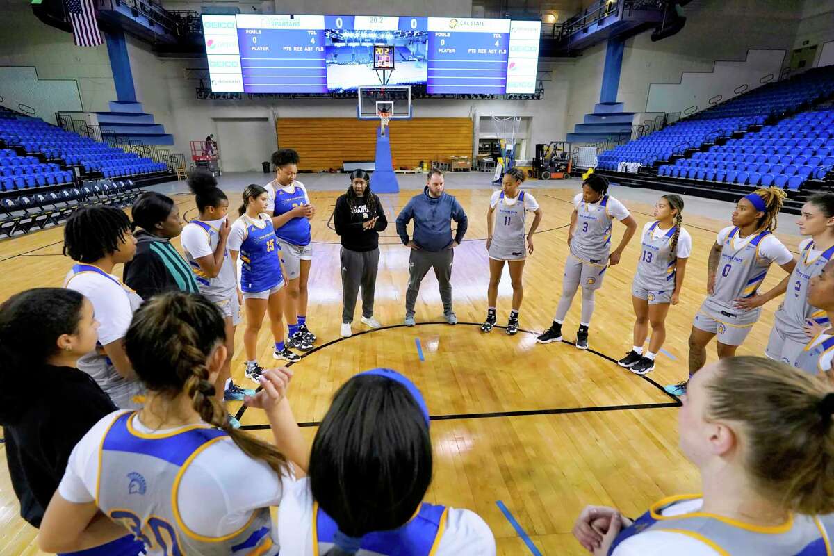 San José State head coach April Phillips, center dressed in black, talks with her players at the end of the team’s practice at the Event Center on Wednesday, Nov. 2, 2022, in San Jose, California.