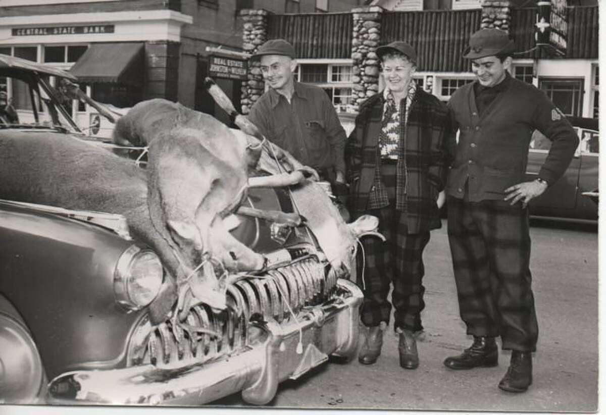 Deer hunting has always been a popular sport in Benzie County, as evidenced by this photo of a car with two deer on the hood in front of Central State Bank.