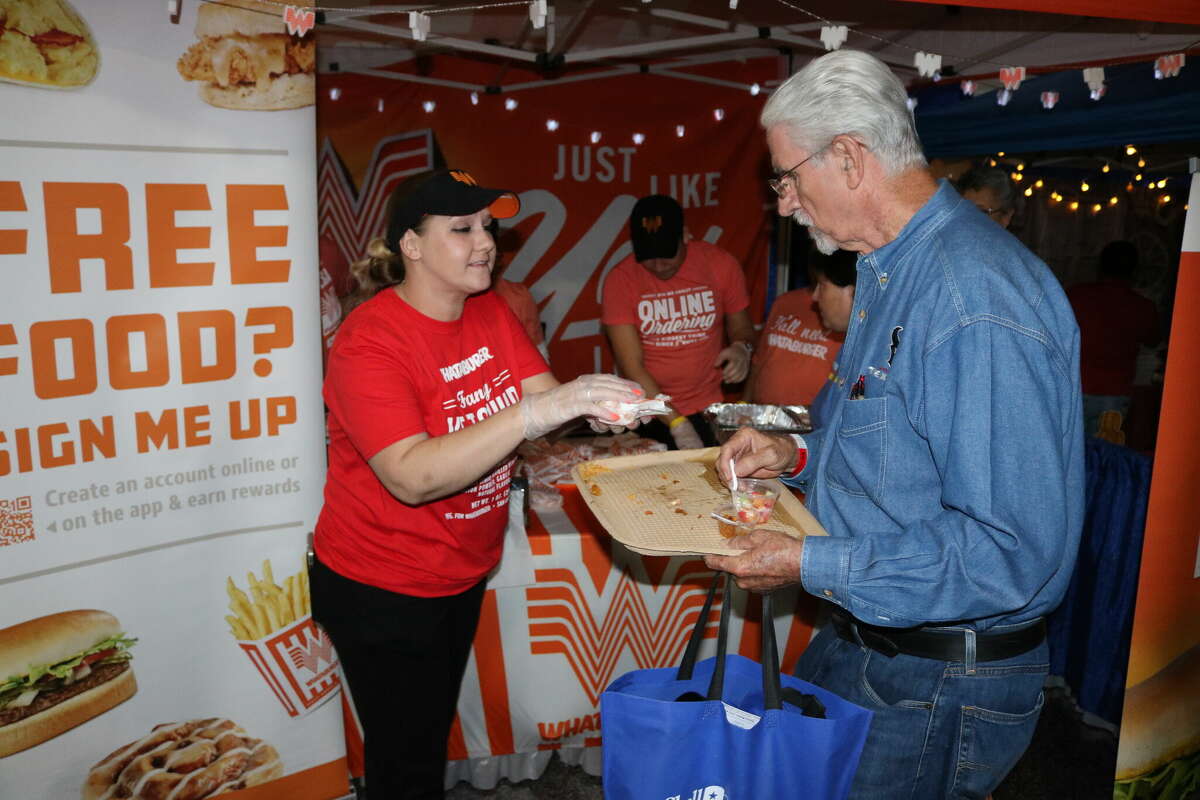 A Whataburger employee gives a customer a sampling at Taste of the Town.