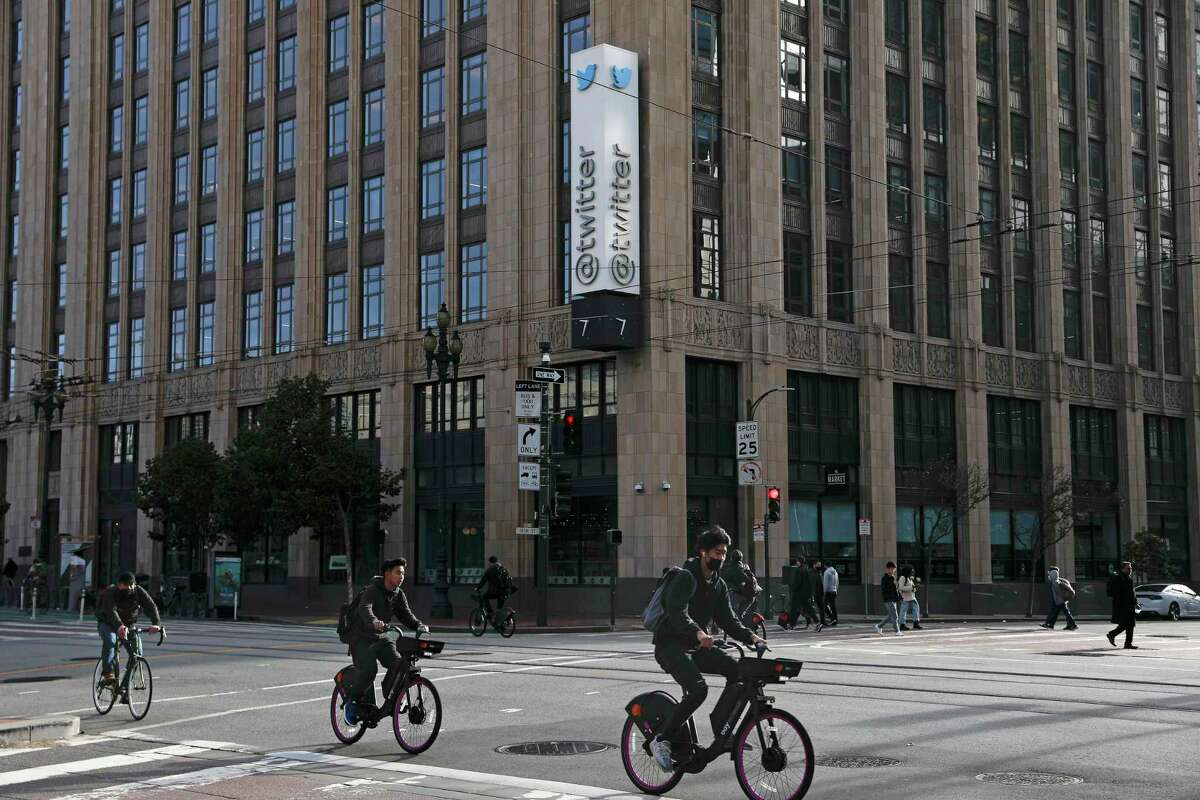 Bicycle riders ride their bikes on Market Street past Twitter headquarters at 1355 Market Street on Friday, November 4, 2022 in San Francisco, Calif.
