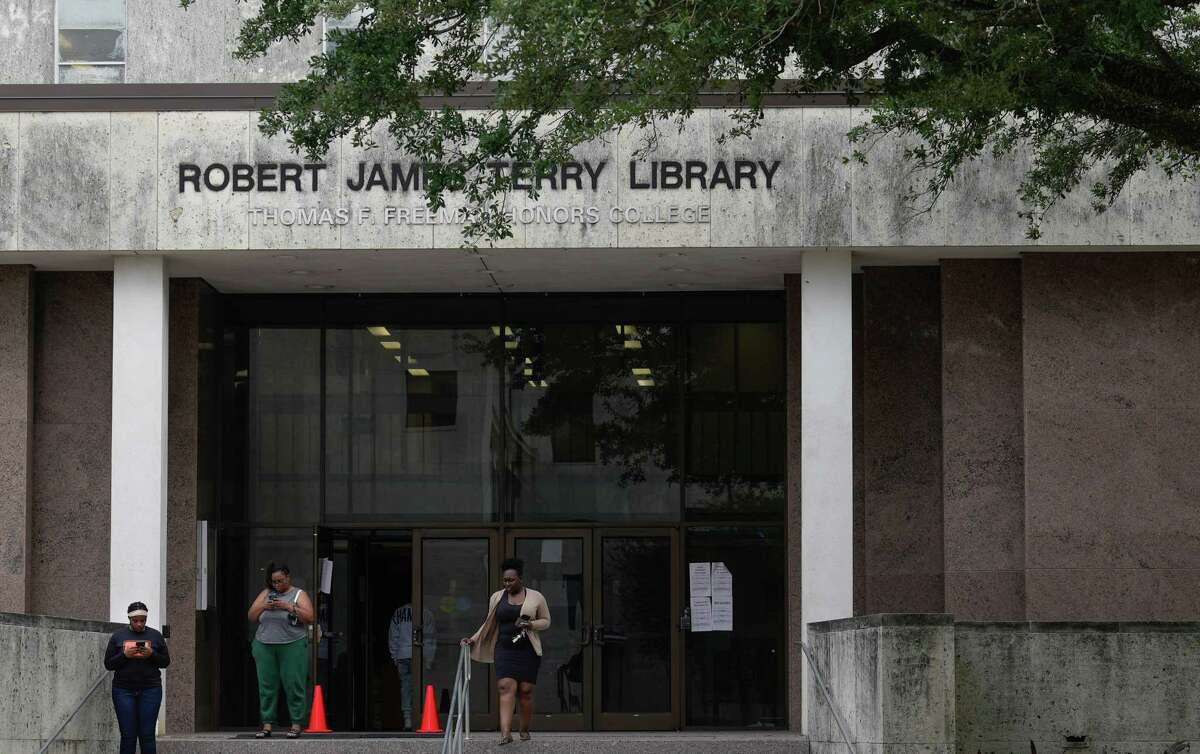 People leave Texas Southern University’s Robert James Terry Library, a poll location, after voting Friday, Nov. 4, 2022, in Houston.