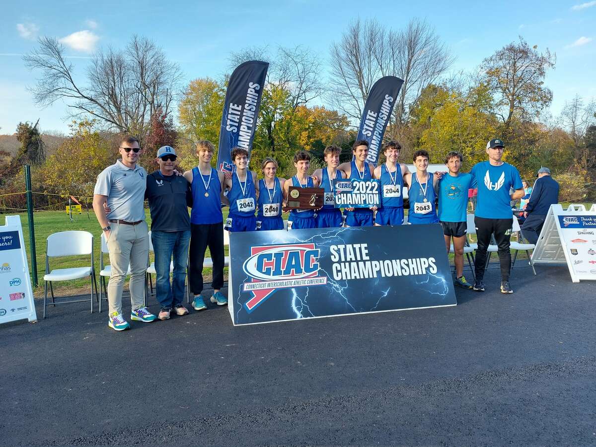Members of the Hall boys cross country team celebrate winning team title with 86 points at CIAC State Open Boys Cross Country championship at Wickham Park Friday, Nov. 4, 2022.