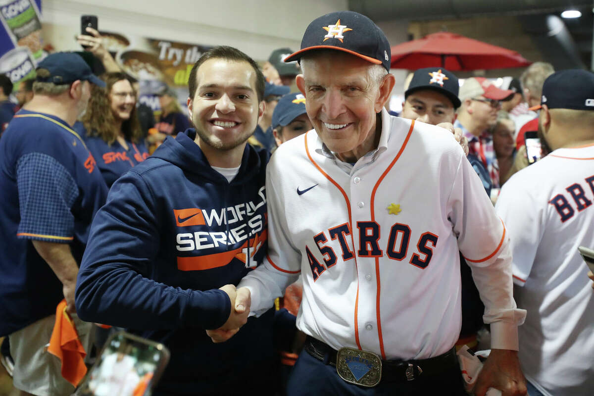 HOUSTON, TEXAS - OCTOBER 28: James Franklin McGingwale, also known as "Mac mattress", poses with fans before Game 1 of the 2022 World Series between the Philadelphia Phillies and the Houston Astros at Minute Maid Park on October 28, 2022 in Houston, Texas.  (Photo by Bob Levy/Getty Images)