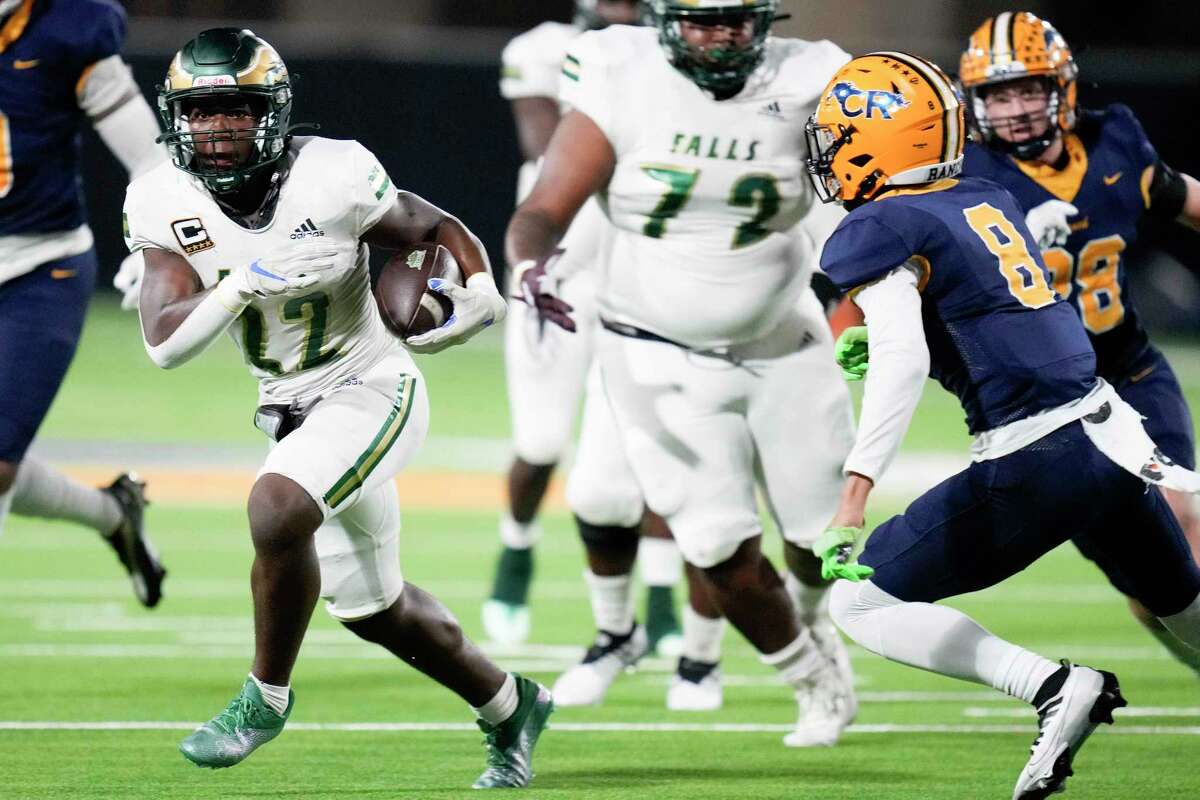 Cy-Falls running back Trey Morris, left, rushes past Cy-Falls defensive back Robert Reedus (8) during the first half of a high school football game, Friday, Nov. 4, 2022, in Cypress.