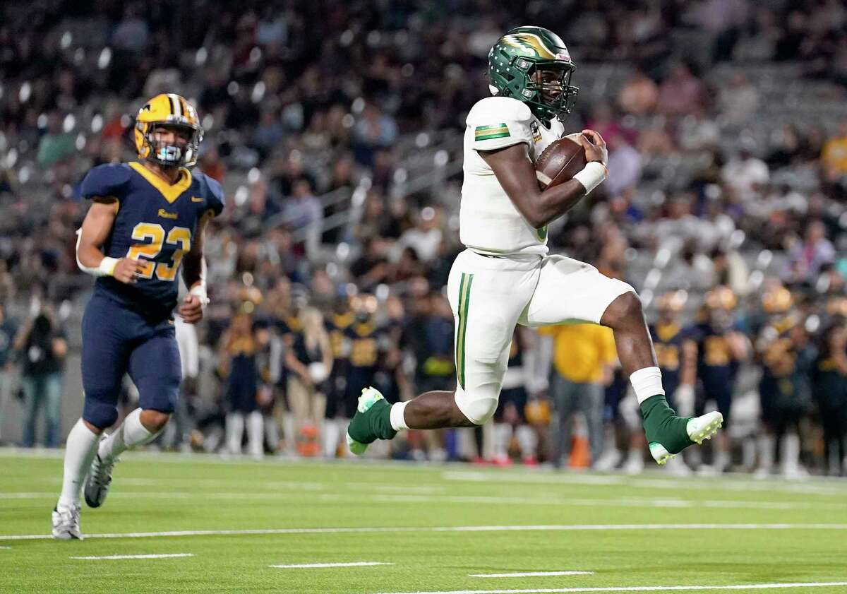 Cy-Falls quarterback Jakob Leavatts, right, leaps into the end zone for a touchdown during the first half of a high school football game against Cy-Ranch, Friday, Nov. 4, 2022, in Cypress.