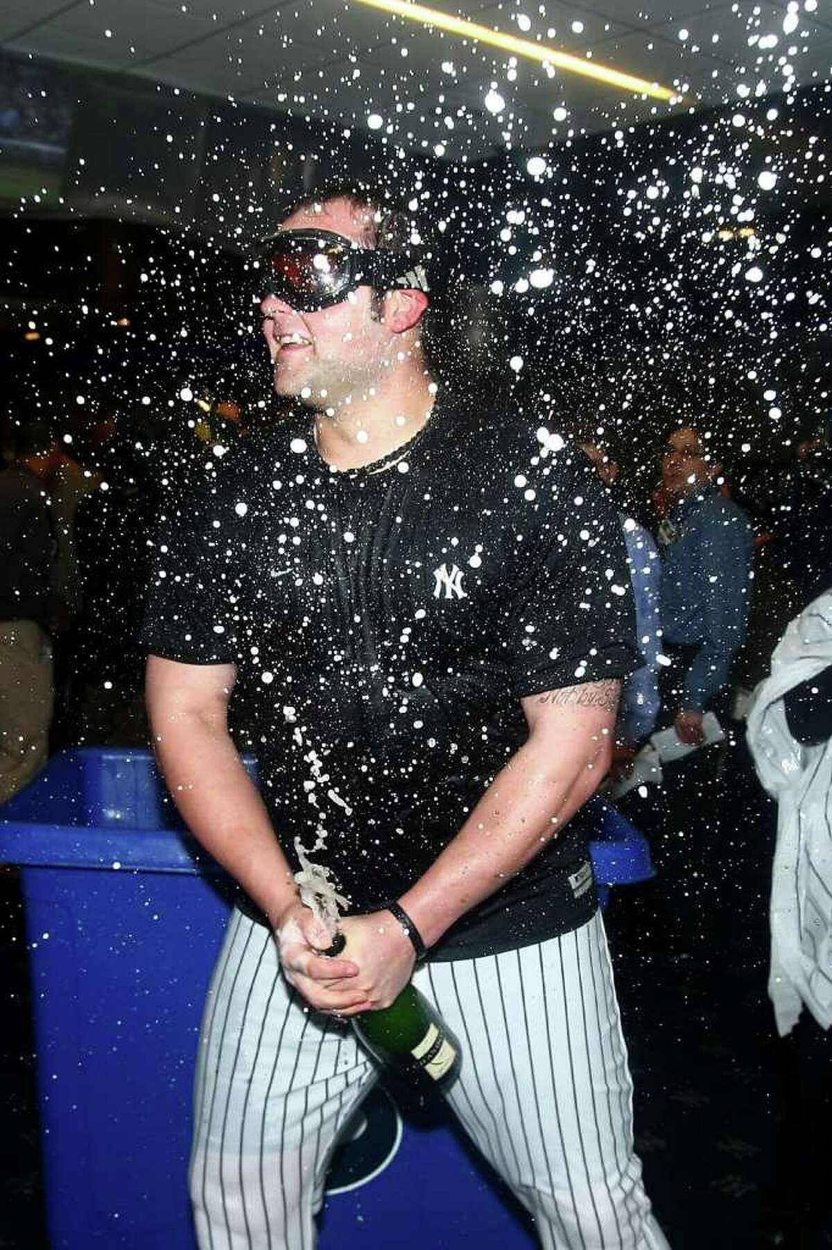 NEW YORK - OCTOBER 09: Joba Chamberlain #62 of the New York Yankees celebrates in the locker room against the Minnesota Twins during Game Three of the ALDS part of the 2010 MLB Playoffs at Yankee Stadium on October 9, 2010 in the Bronx borough of New York City. (Photo by Jim McIsaac/Getty Images) *** Local Caption *** Joba Chamberlain