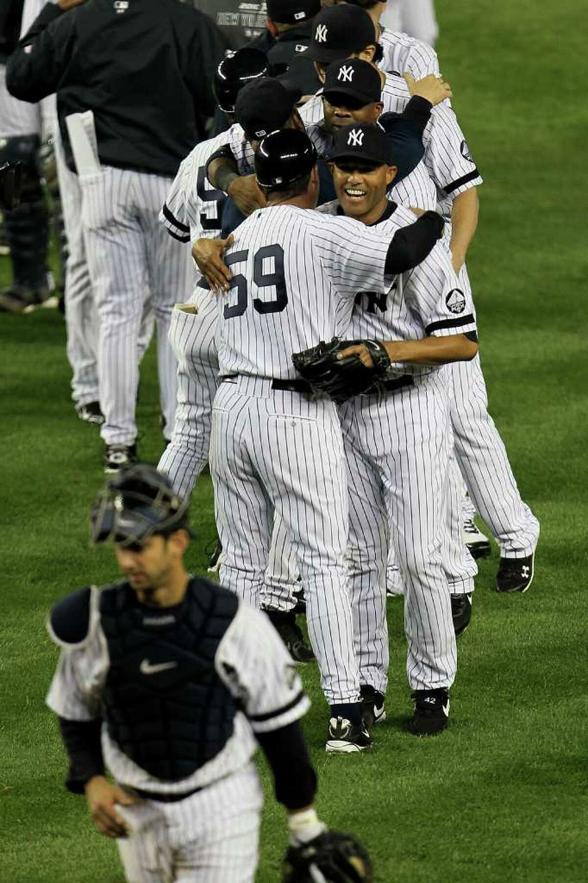 NEW YORK - OCTOBER 09: Mariano Rivera #42 of the New York Yankees celebrates with his teammates after their 6-1 win against the Minnesota Twins during Game Three of the ALDS part of the 2010 MLB Playoffs at Yankee Stadium on October 9, 2010 in the Bronx borough of New York City. (Photo by Chris McGrath/Getty Images) *** Local Caption *** Mariano Rivera