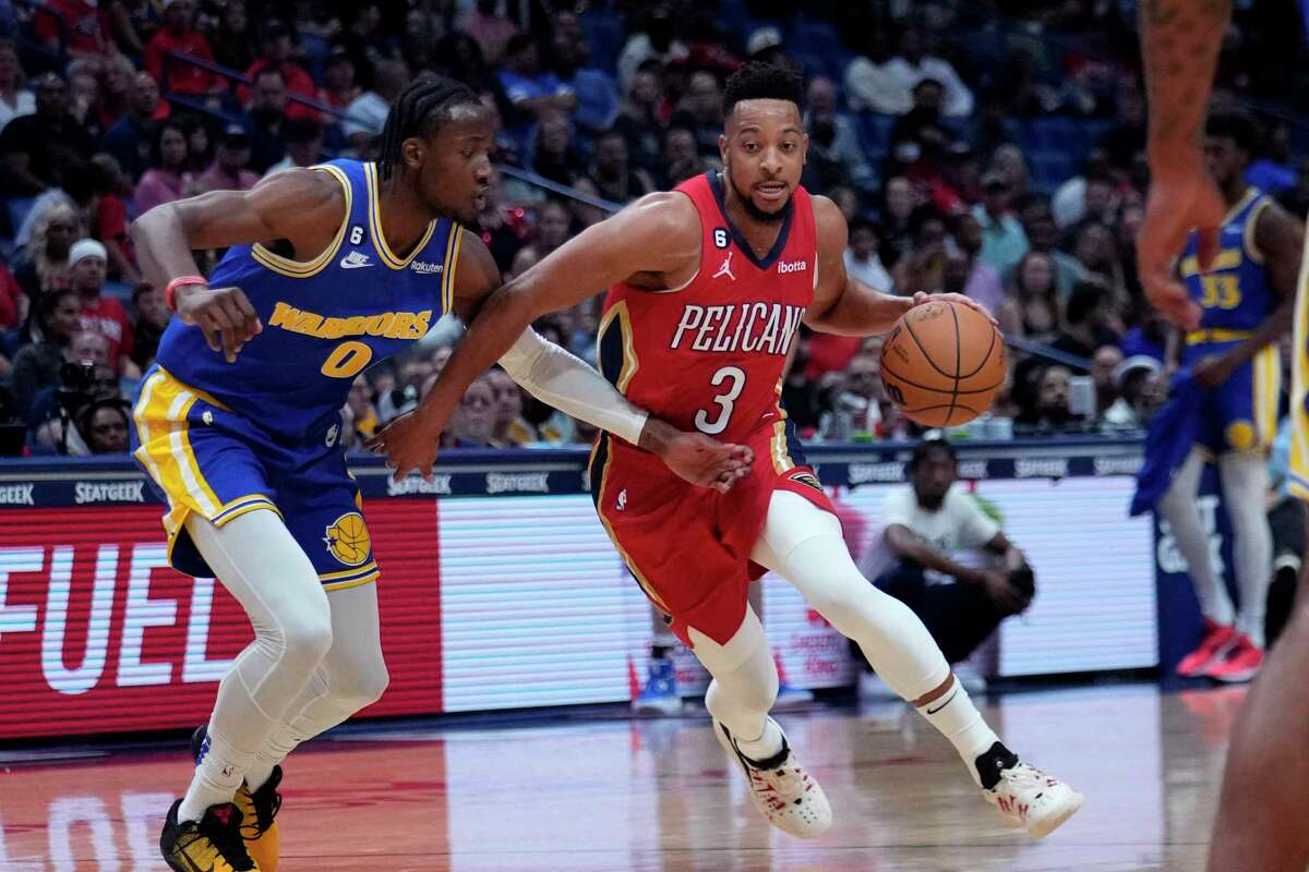 New Orleans Pelicans guard CJ McCollum (3) drives to the basket against Golden State Warriors forward Jonathan Kuminga in New Orleans, Friday, Nov. 4, 2022.