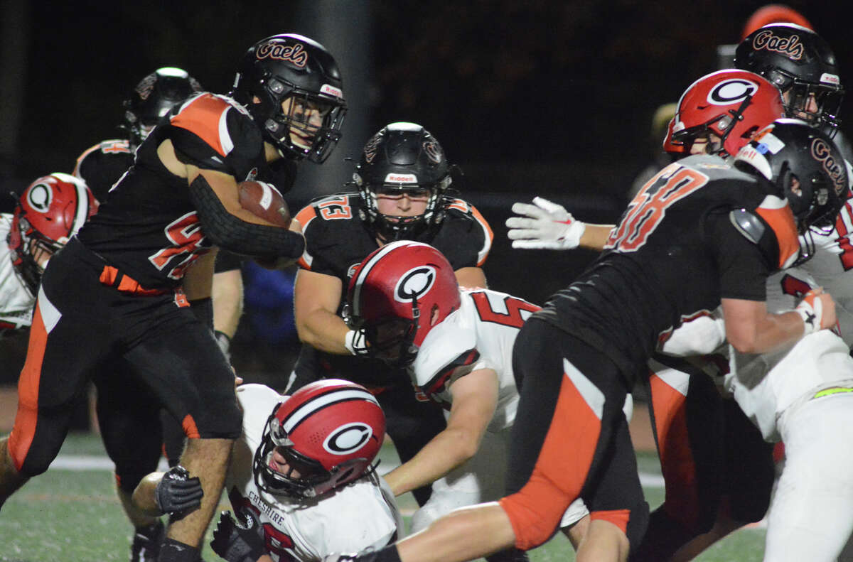 Shelton's Tyler DeSousa tries to escape the grasp of Cheshire's Evan Russo during the football game between Shelton and Cheshire on Friday, Nov. 4, 2022.