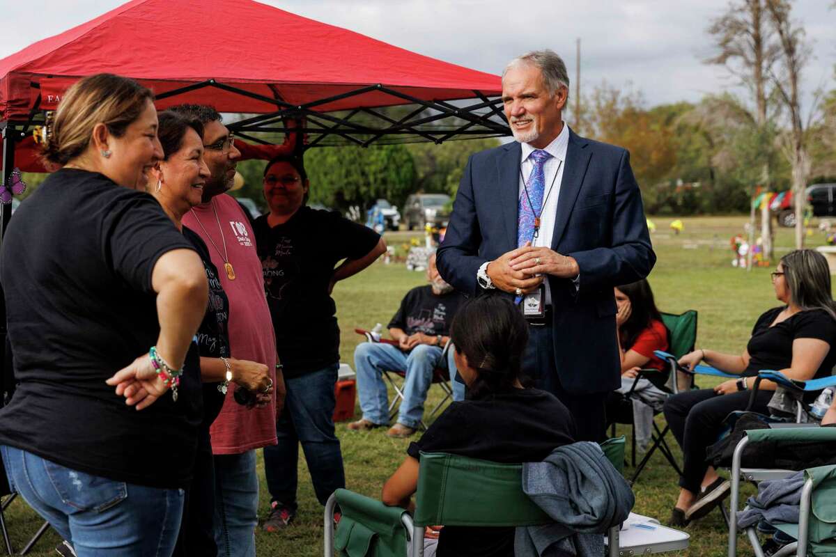 Uvalde’s interim school superintendent, Gary Patterson, introduces himself to Tess Mata’s family during a Día de los Muertos gathering at Hillcrest Memorial Cemetery in Uvalde on Wednesday, Nov. 2, 2022. Mata was one of 19 children killed in the Robb Elementary School mass shooting. Her mother Veronica Mata, left, is a Uvalde CISD teacher.