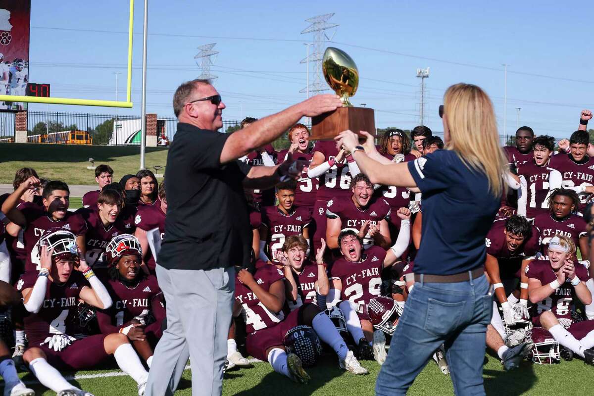 Cy-Fair players celebrate as head coach Jeff Miller receives the District Trophy after a 45-21 Bobcat win in a District 17-6A high school football game between the Memorial Mustangs and the Cy-Fair Bobcats at Pridgeon Stadium in Houston, TX on Saturday, November 5, 2022.