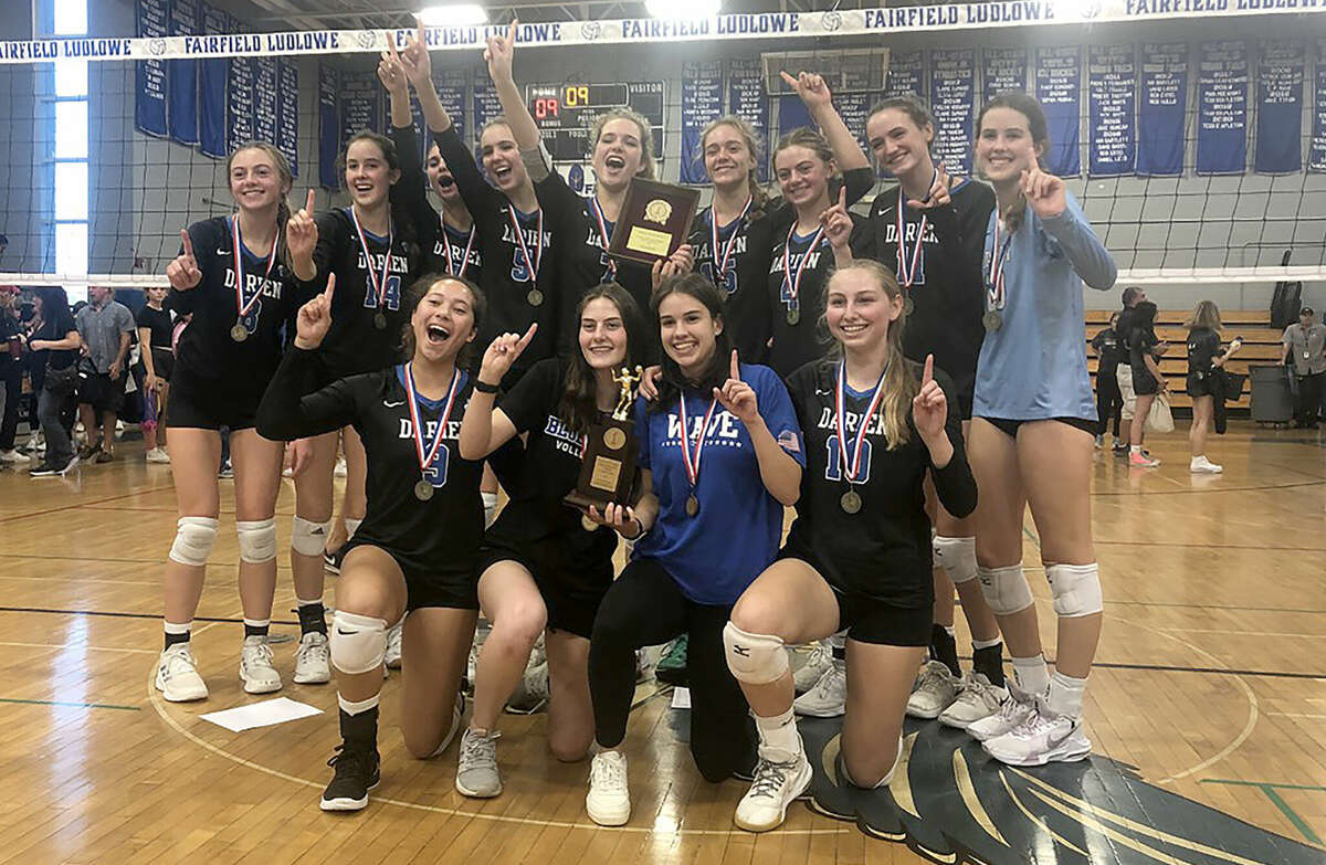 The Darien girls volleyball team celebrates after defeating Trumbull 3-2 for the FCIAC championship at Fairfield Ludlowe on Saturday, Nov. 5, 2022.