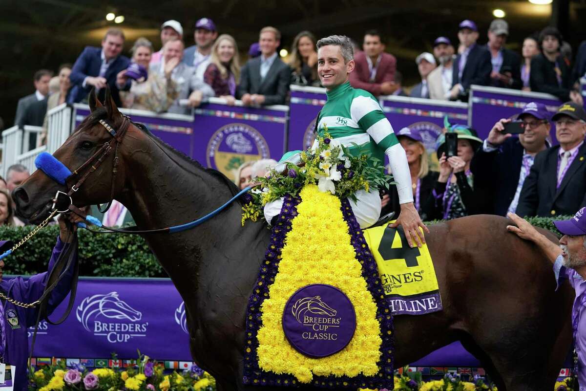 Flavien Prat poses in the winner's circle after riding Flightline to victory during the Breeders' Cup Classic raceat the Keenelend Race Course, Saturday, Nov. 5, 2022, in Lexington, Ky. (AP Photo/Darron Cummings)