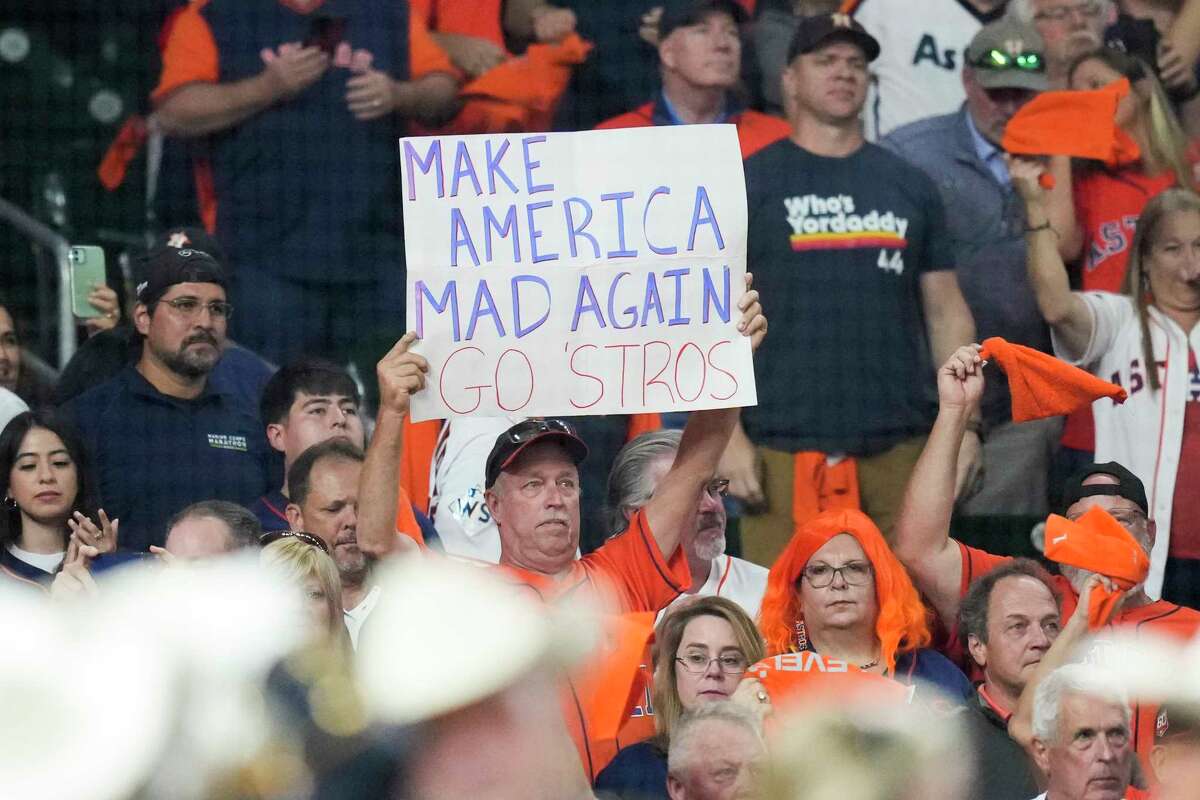A fan holds up a sign that reads “Make America Mad Again Go ‘Stros” before Game 6 of the World Series at Minute Maid Park on Saturday, Nov. 5, 2022, in Houston.