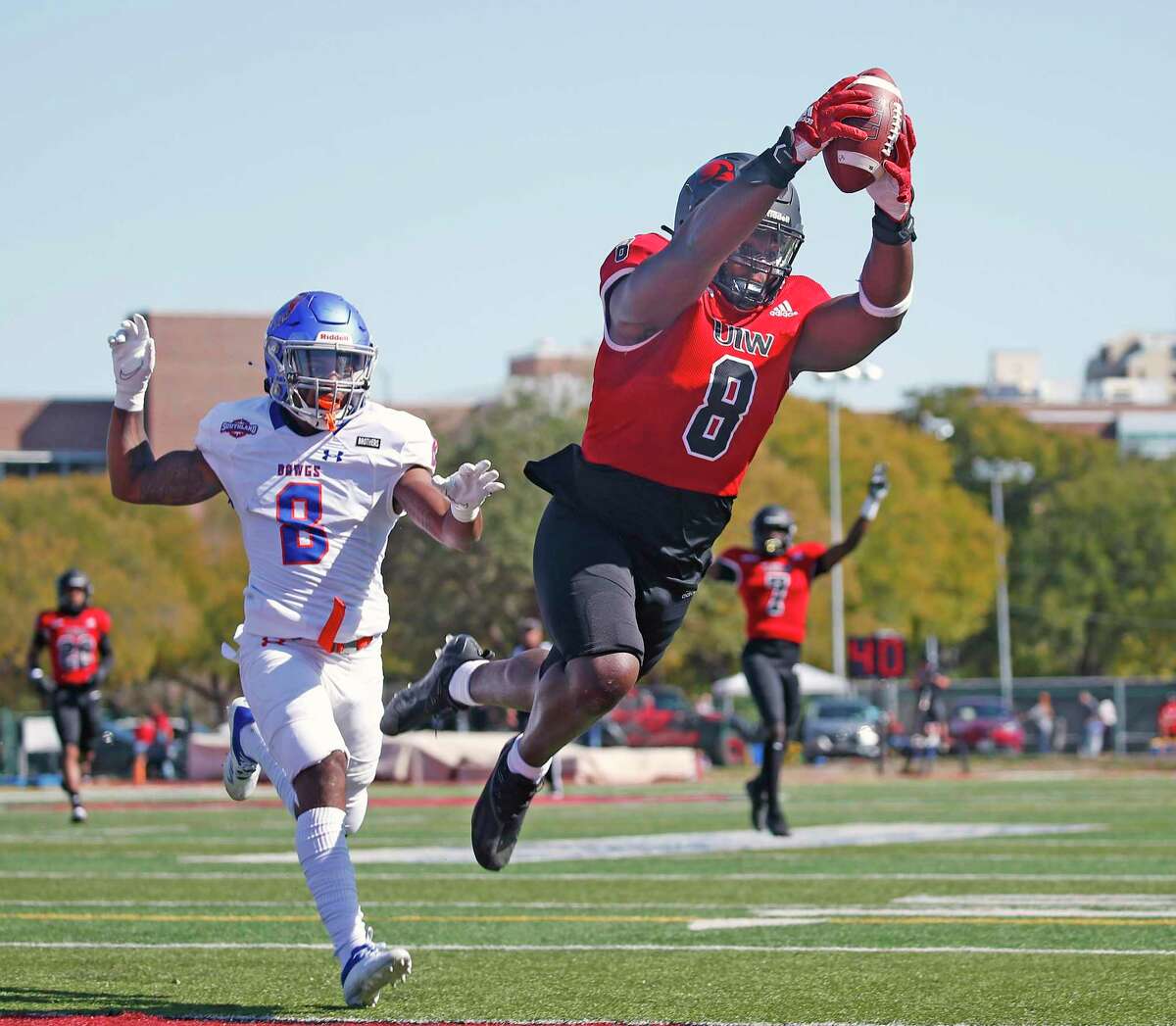 Incarnate Word’s Kelechi Anyalebechi dives for the end zone to score on a pick-six in Saturday’s 73-20 win over HCU.