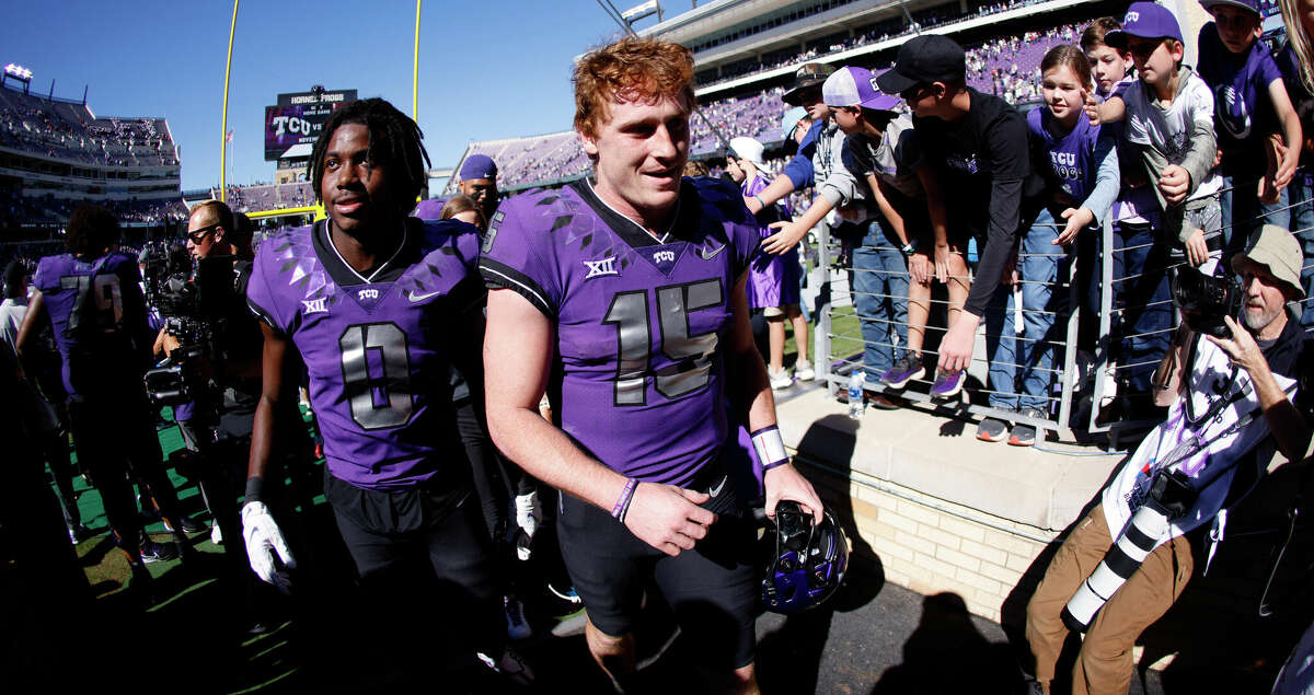 TCU quarterback Max Duggan (15) and wide receiver Blair Conwright (0) celebrate with fans following the team's 34-24 win over Texas Tech in an NCAA college football game Saturday, Nov. 5, 2022, in Fort Worth, Texas. (AP Photo/Ron Jenkins)
