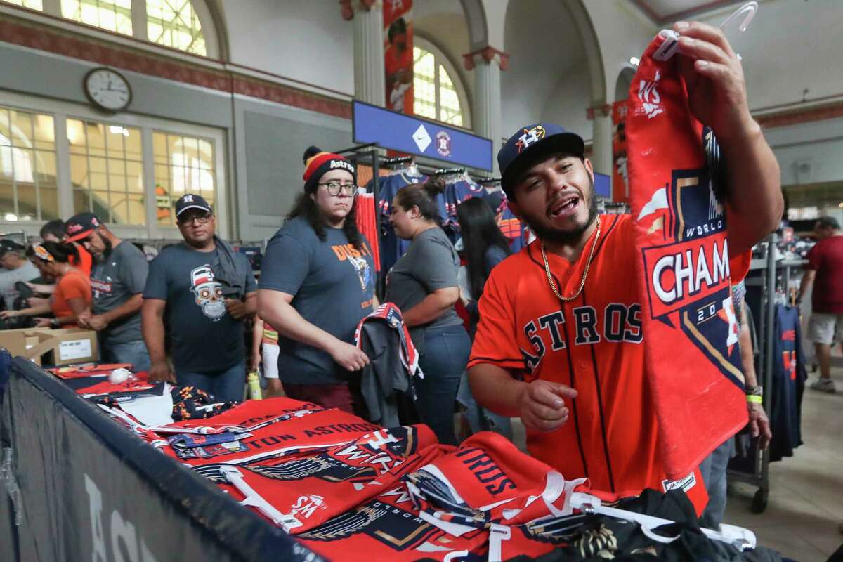 Jaime Miranda sorts through World Series gear as fans flock to Minute Maid Park after the team’s championship, Sunday, Nov. 6, 2022, in Houston.