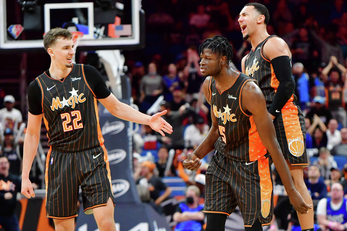 ORLANDO, FLORIDA - MARCH 11: Franz Wagner #22 (left), Mo Bamba #5 (middle), and Jalen Suggs #4 (right) of the Orlando Magic react during the fourth quarter Minnesota Timberwolves at Amway Center on March 11, 2022 in Orlando, Florida.  (Photo by Julio Aguilar/Getty Images)