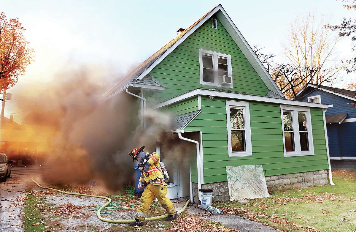 John Badman|Ther Telegraph Smoke billows from the house as Alton firefighters work to extinguish it early Monday morning.
