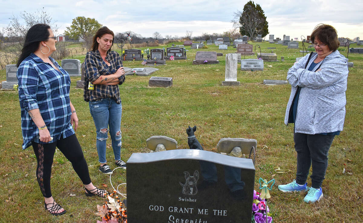 Chastity Scoggins, Kelsey Sprong and Mary Oakley visit the grave of Andrew Long at Richwood Cemetery west of Carrollton. Long died Oct. 18, 2017, after being found injured in the street in Manchester. Scoggins is Long's sister, Sprong is his longtime girlfriend, and Oakley is his mother. They are trying to bring attention to his death and finding out who is responsible.