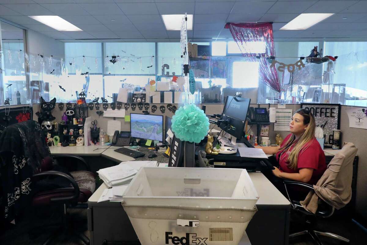 Chesmar Homes employee Melissa Master, who works in post closings, at her personally decorated cubicle at the division offices Wednesday, Sept. 21, 2022 in The Woodlands, TX.