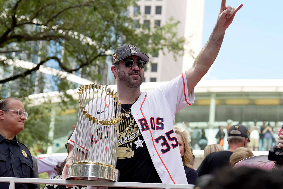 Houston Astros pitcher Justin Verlander holds the trophy as the Astros World Series victory parade makes it’s way down Smith St. in downtown Houston on Monday, Nov. 7, 2002.