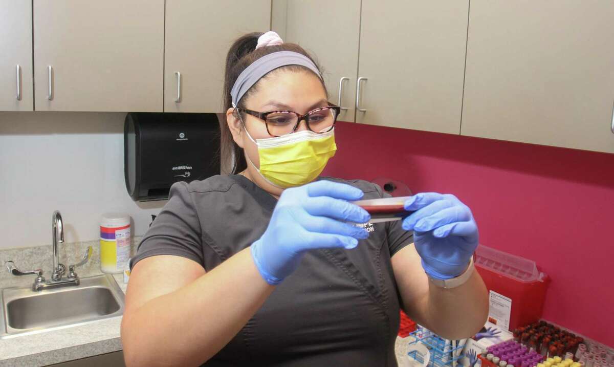 Medical assistant Eve Munoz doing lab work at St. Hope Foundation in Sugar Land last year. St. Hope Foundation is a nonprofit healthcare provider for predominantly low-income communities.