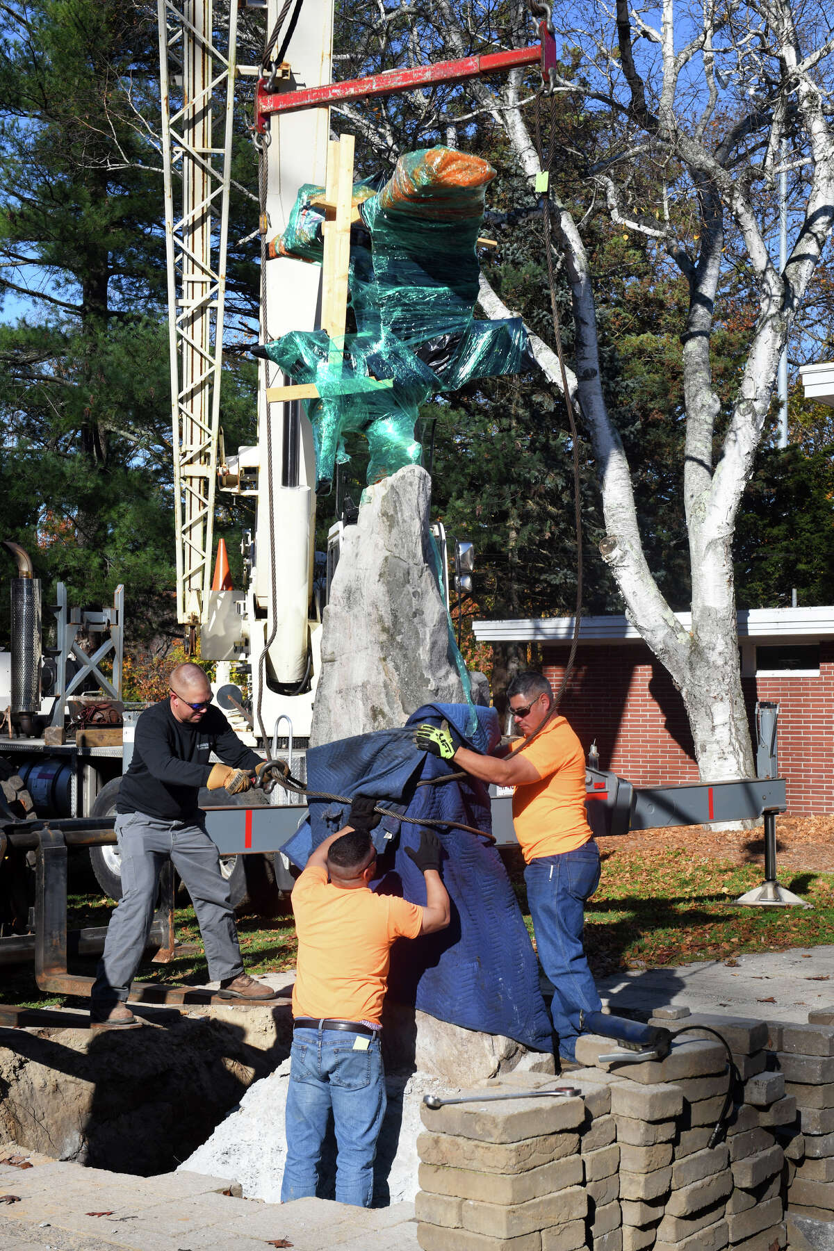 The Eagle monument is moved from the spot where it has stood for generations in front the old War Memorial at Riverview Park, in Shelton, Conn. Nov. 7, 2022. The monument is being moved to Veterans Memorial Park on Canal St.