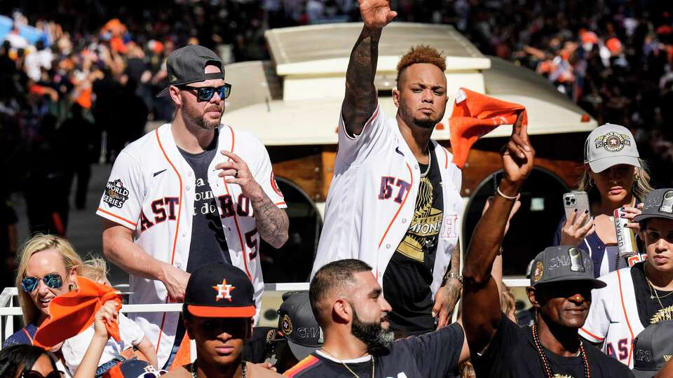 Houston Astros Ryan Pressly, left, and Martin Maldonado wave to the fans during the Astros World Series championship parade on Monday, Nov. 7, 2022 in Houston.