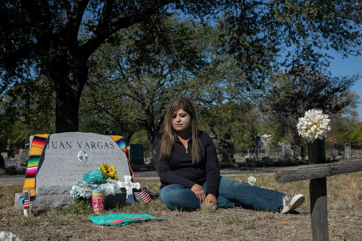Roxie Vargas sits near the headstone of her great-great- grandfather Juan Vargas at St. Mary’s Catholic Cemetery.