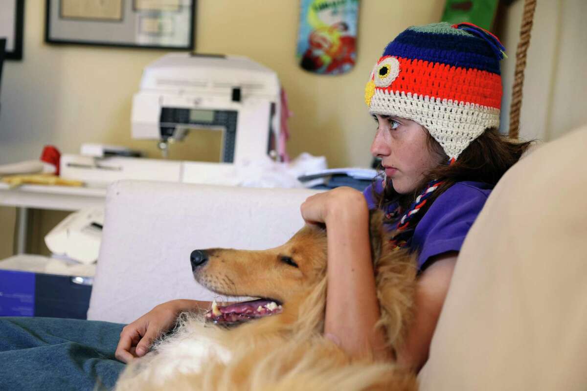 Minna Stess, a 16-year-old Olympic hopeful skateboarder, spends time with Esther, her family’s collie, at her home in Petaluma, Calif., on Tuesday, September 27, 2022.