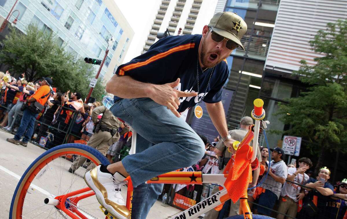 A cyclist passes along the 2022 World Series Championship Parade Monday, Nov. 7, 2022, in downtown Houston. About 105,000 trips were taken on Metropolitan Transit Authority light rail on Monday, officials said, the third-highest daily total ever.