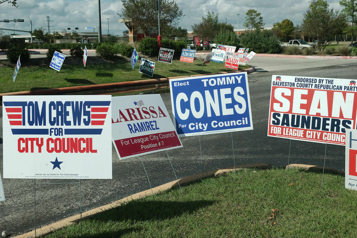 Campaign signs for candidates running for the League City City Council sit outside a polling location in League City.