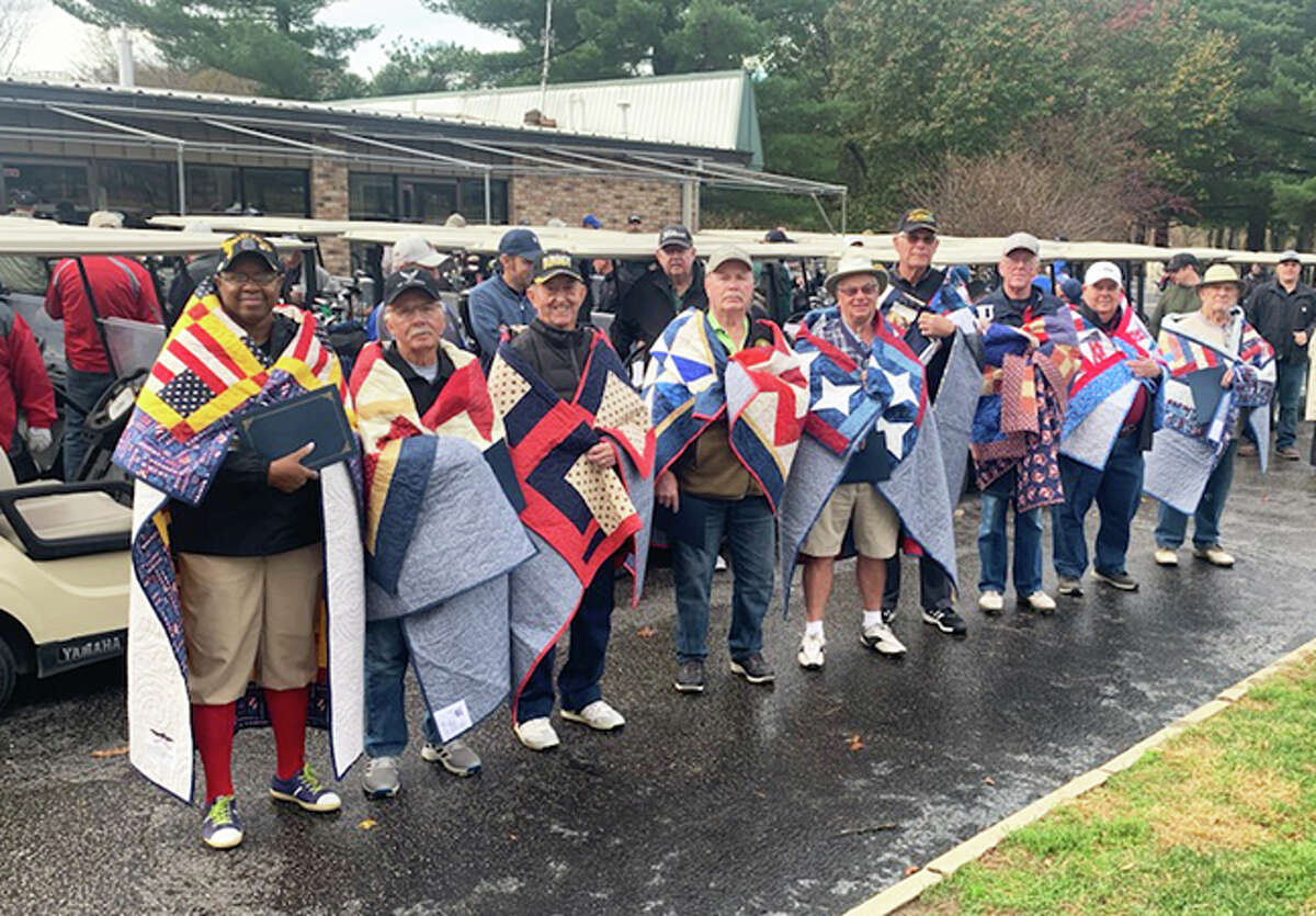 The eighth annual Veterans Day Golf Tournament, held on Nov. 5 at Oak Brook Golf Club in Edwardsville, included the presentation of quilts to nine veterans by Quilts of Valor. The event is a fundraiser for Veterans Caring for Veterans.