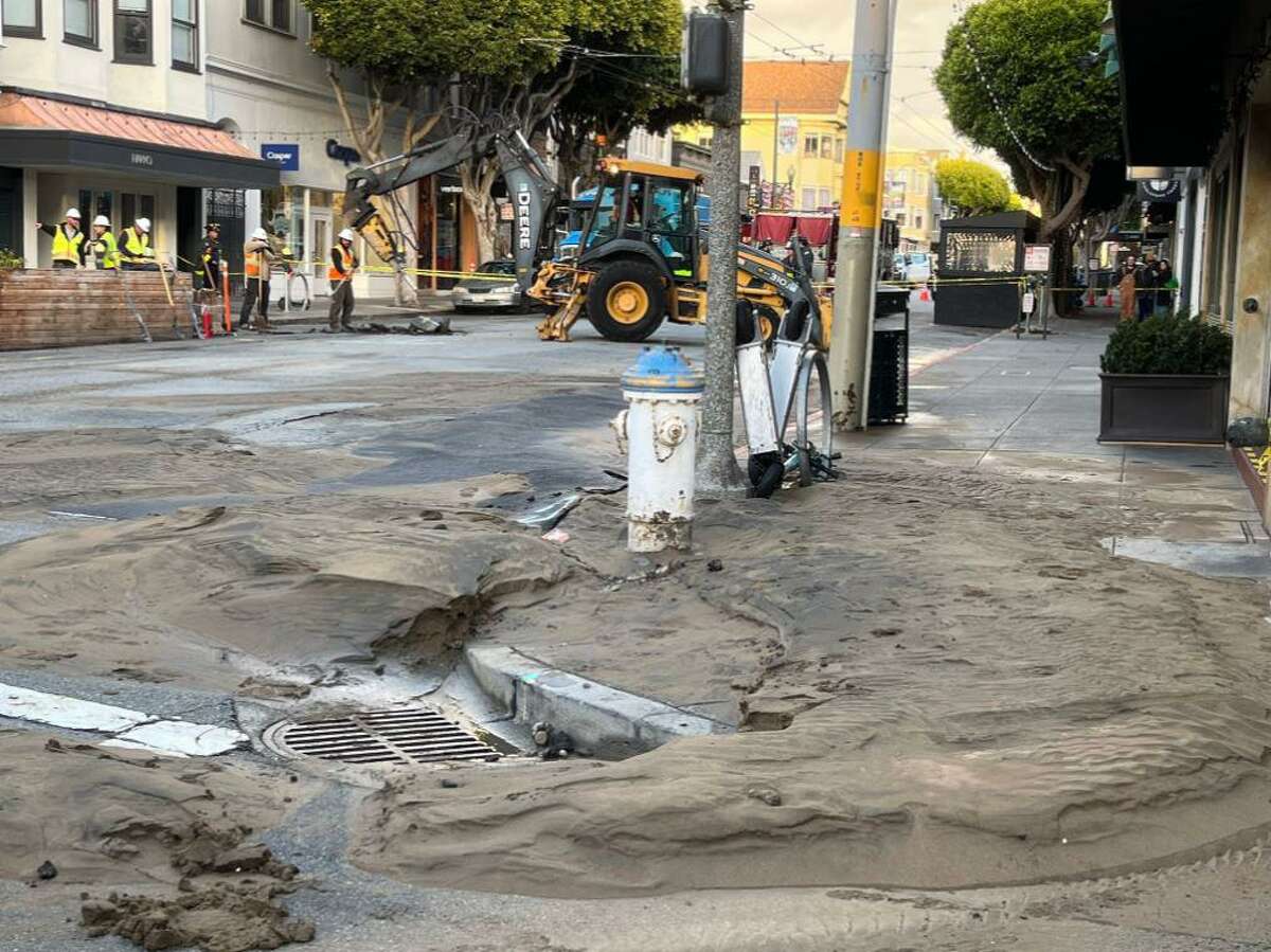 A broken water main beneath the pavement flooded the busy commercial intersection of Union and Fillmore Streets in San Francisco on Monday, Nov. 7, 2022.