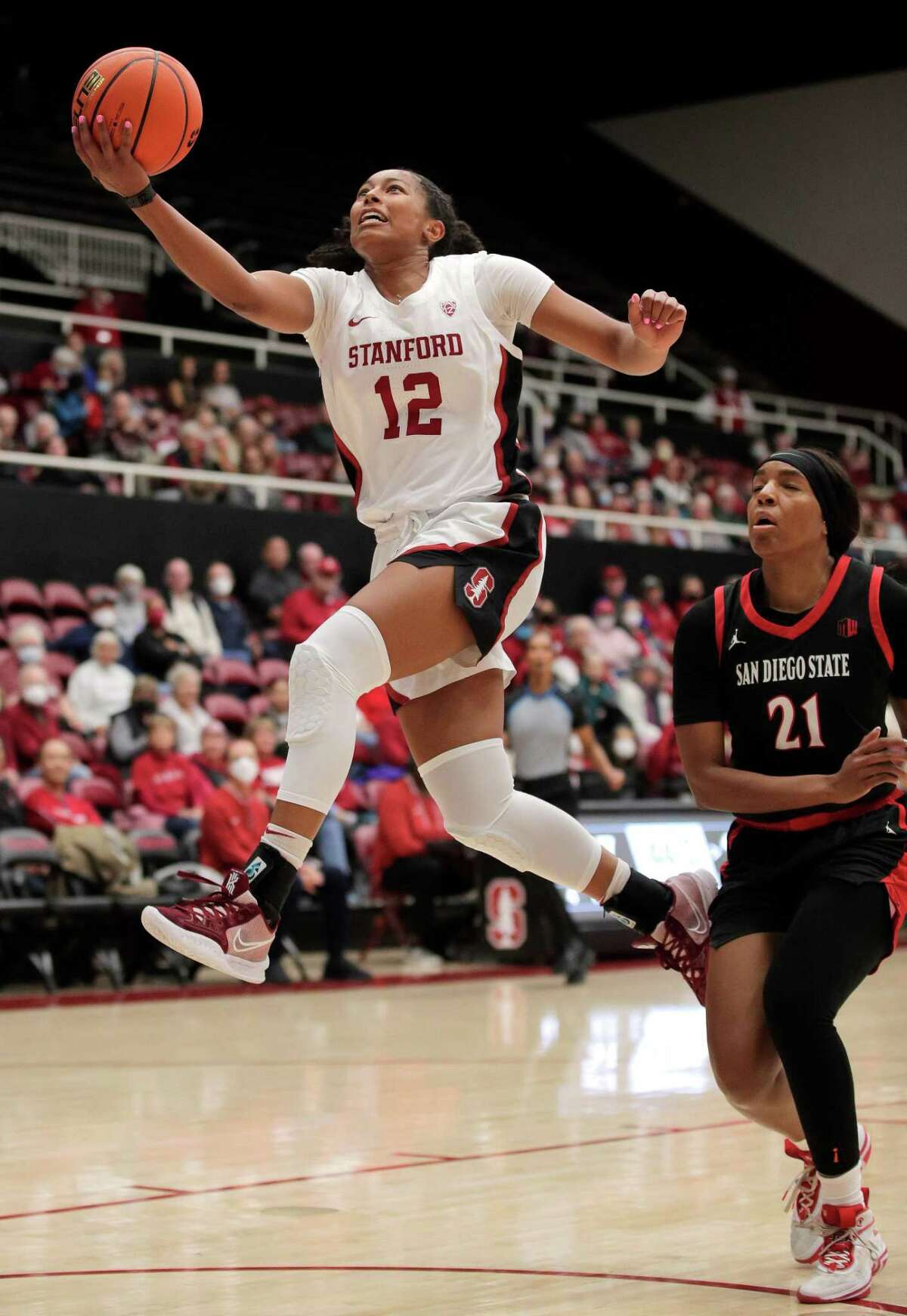Stanford’s Indya Nivar (12) drives in for a layup after a steal past Alex Crain (21) In the first half as the Stanford Cardinal played the San Diego State Aztecs at Maples Pavilion in Stanford, Calif., on Monday, November 07, 2022.