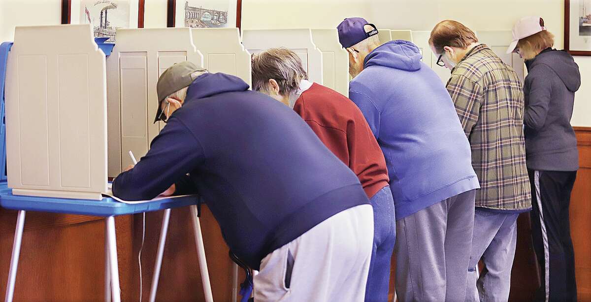 John Badman|The Telegraph Voters in Alton Precinct 1, located at Alton City Hall, line up to vote Tuesday where voting booths were rarely empty through the morning. Voting was heavy and steady early in the day.