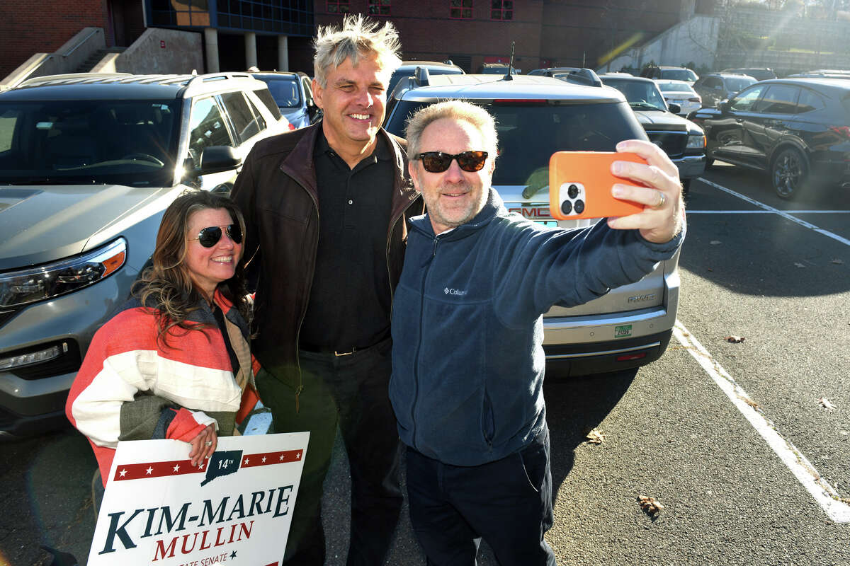 Bob Stefanowski, center, Republican candidate for Governor, poses with State Senate candidate Kim-Marie Mullin and her supporter, Andy Weinstein, outside Foran High School on Election Day in Milford, Conn. Nov. 8, 2022.