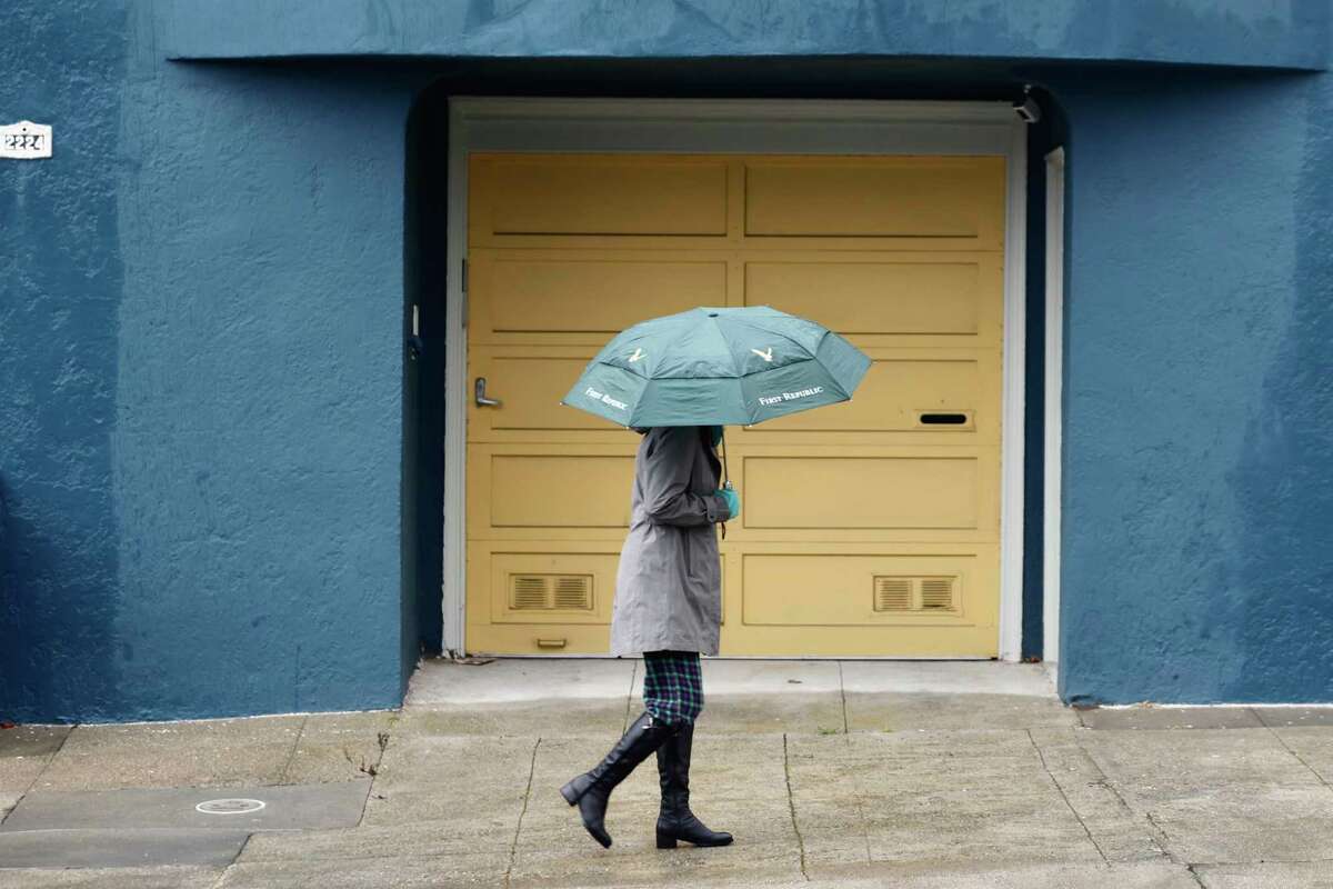 A person carries an umbrella while walking up Lawton Street in San Francisco, Calif. Tuesday, November 8, 2022 as rain falls on Election Day.