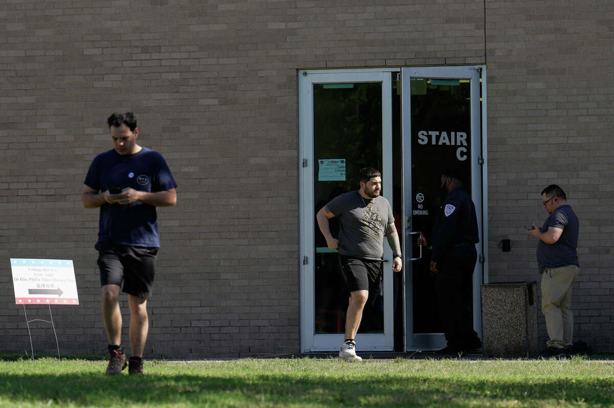 People leave after voting at BakerRipley House on Tuesday. It was reported this poll site had door problems and caused long line at the location. As a result, people were asked to vote at the nearby Eastwood Community Center.