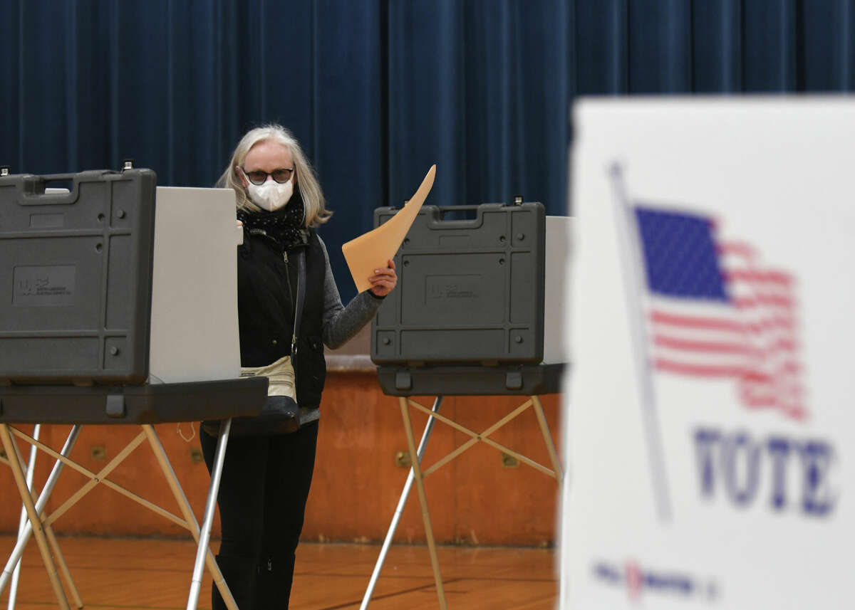 Norwalk resident Corry Soetens casts her ballot at the District E-1 polling center at Brookside Elementary School in Norwalk, Conn. on Election Day, Tuesday, Nov. 8, 2022.