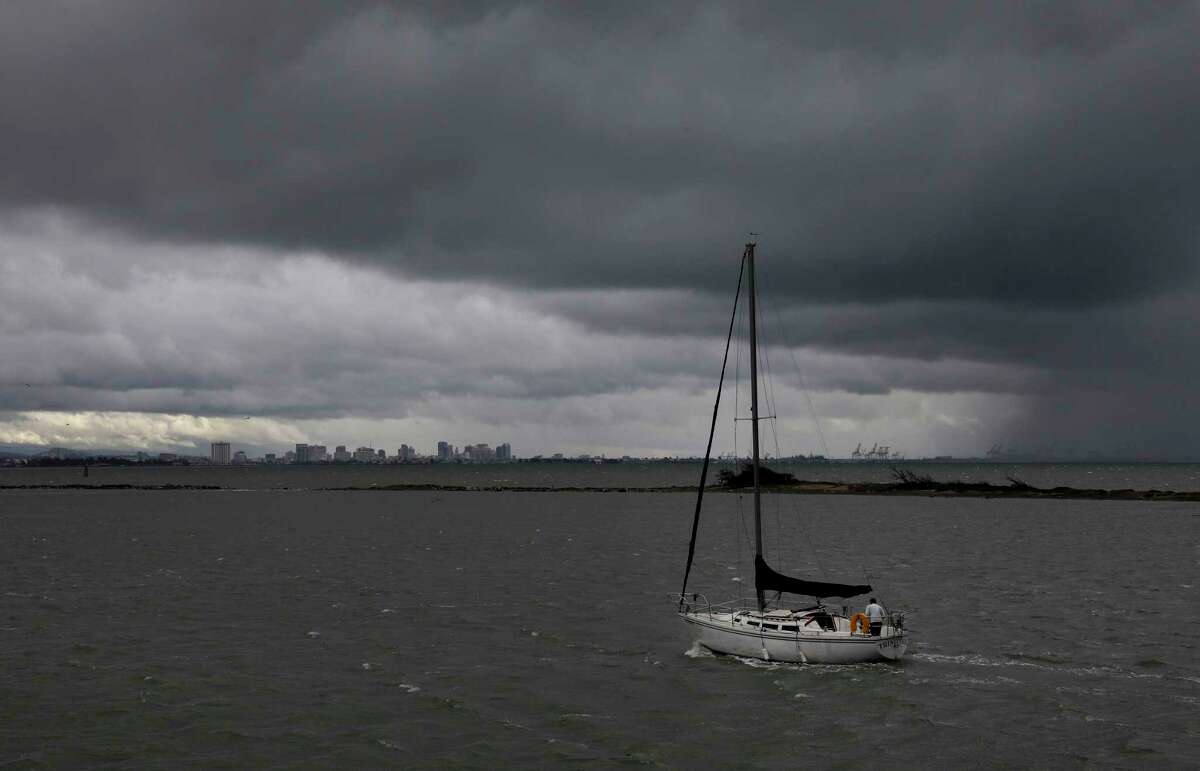 A sailboat navigates Point Potrero Reach as dark clouds move into Oakland on Tuesday November 8, 2022. Significant rains came rolling through San Francisco along with the usual fog this week.