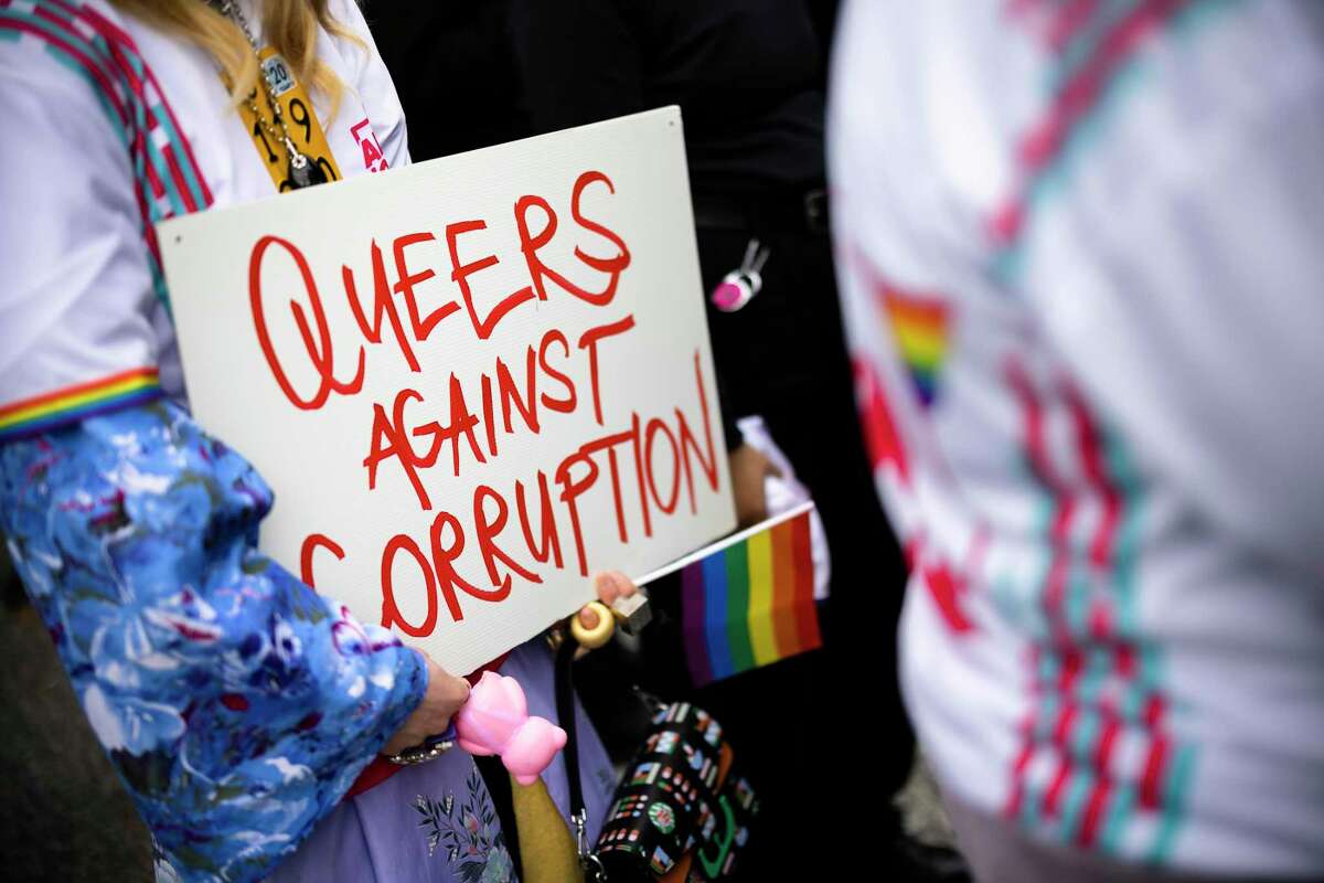 A protestor in Zurich holds a sign during a rally Tuesday to raise awareness of human rights of LGBTQ people in Qatar.