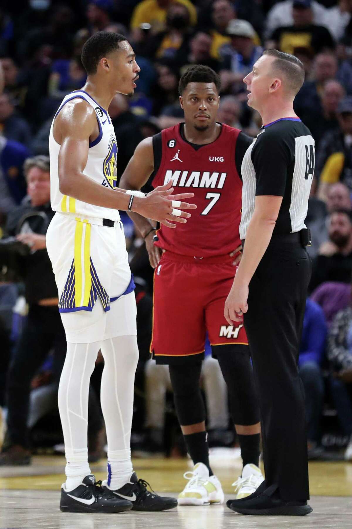 Golden State Warriors’ Jordan Poole discusses his technical foul with official Justin Van Duyne as Miami Heat’s Kyle Lowry looks on during Warriors’ 123-110 win in NBA game at Chase Center in San Francisco, Calif., on Thursday, October 27, 2022.