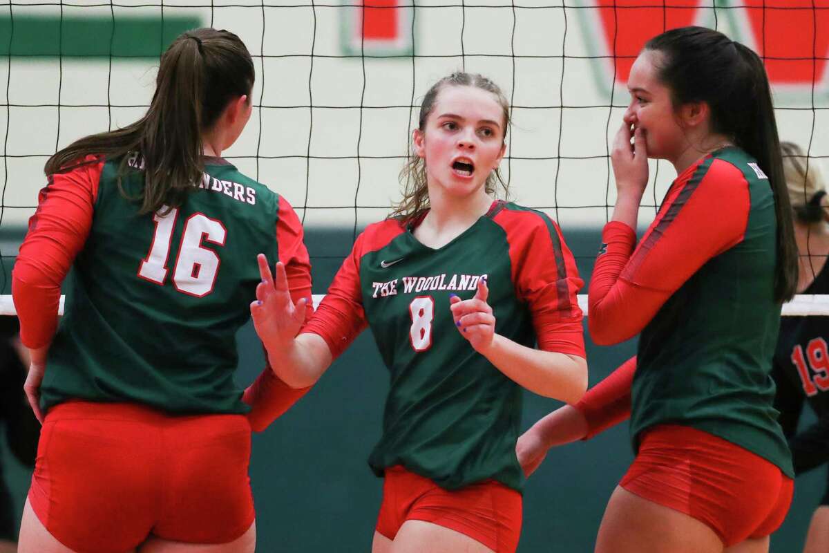 The Woodlands outside hitter Makenzie Weddel (8) talks with teammates before a serve in the fourth set during a Region II-6A quarterfinal volleyball match at The Woodlands High School, Tuesday, Nov. 8, 2022, in The Woodlands.