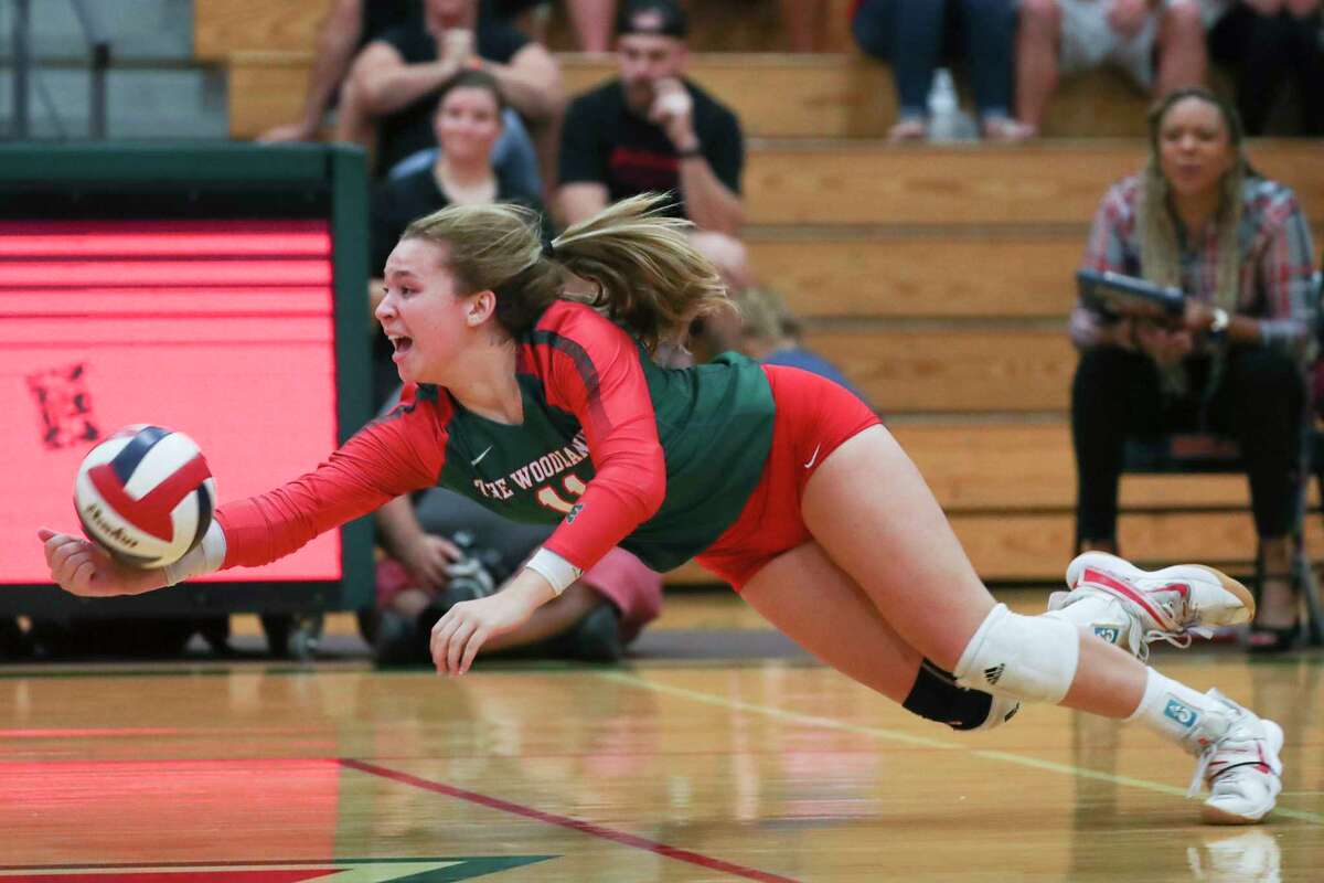 The Woodlands setter Olivia Chojnacki (11) digs the ball in the fifth set during a Region II-6A quarterfinal volleyball match at The Woodlands High School, Tuesday, Nov. 8, 2022, in The Woodlands.