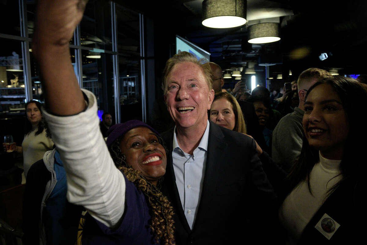 Gov. Ned Lamont stops for a photograph as he leaves the stage after speaking to the crowds gathered at the Democratâs election night gathering, Dunkin' Donuts Park, Hartford, Conn. Tuesday night, November 7, 2022.